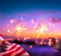 Usa,celebration,with,hands,holding,sparklers,and,american,flag,at